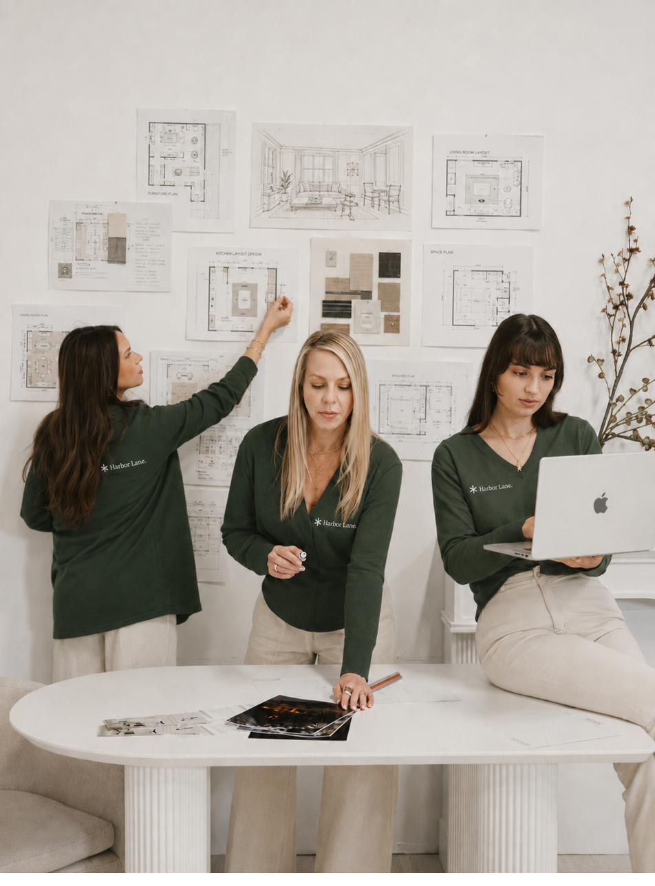 Harbor Lane team members reviewing floor plans and furniture layouts.